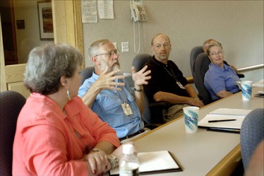 people-seated-at-table-participating-in-group-discussion-during-meeting